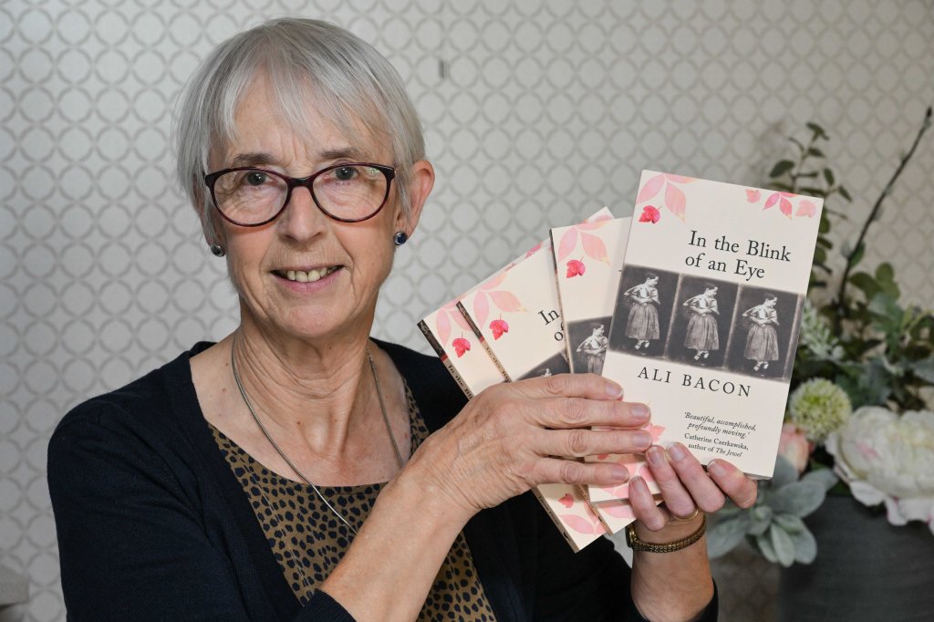 Image of Ali Bacon with copies of In the Blink of an Eye