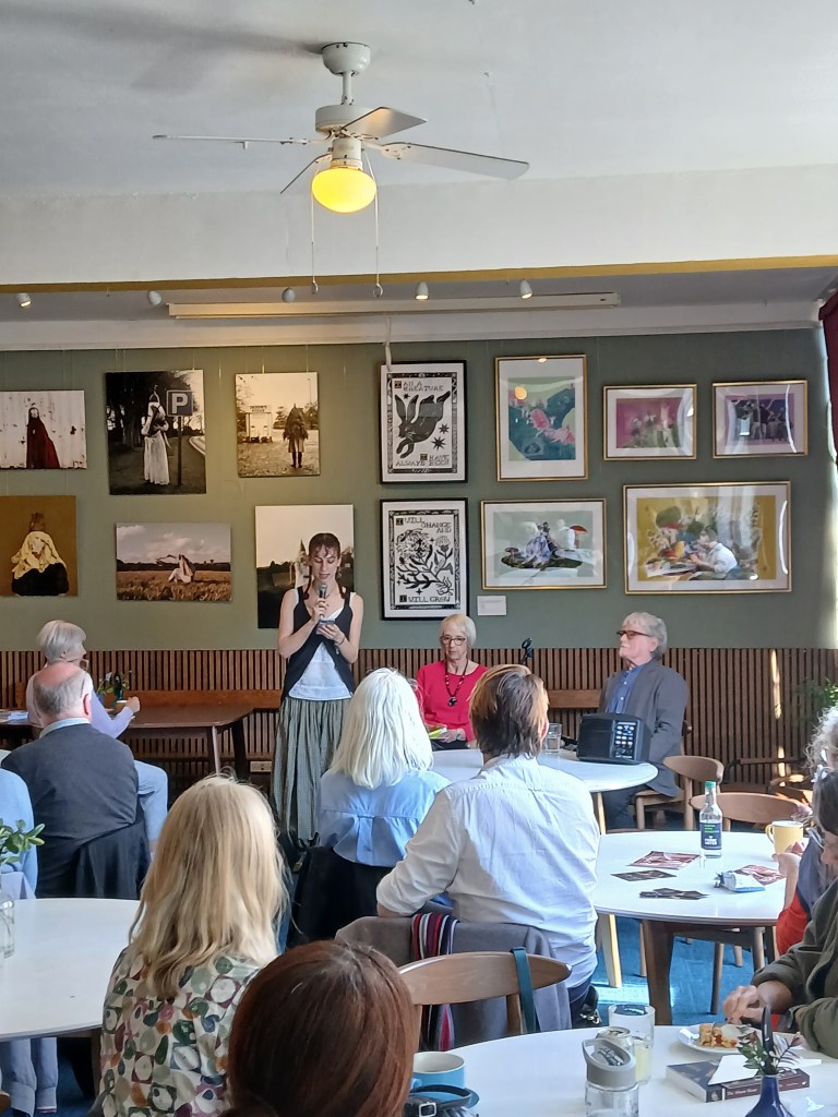 Image shows audience and speakers at Bristol Folk House